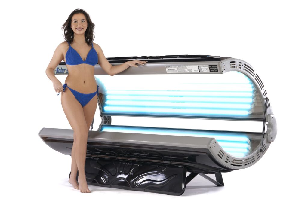 Woman in swimsuit next to tanning bed